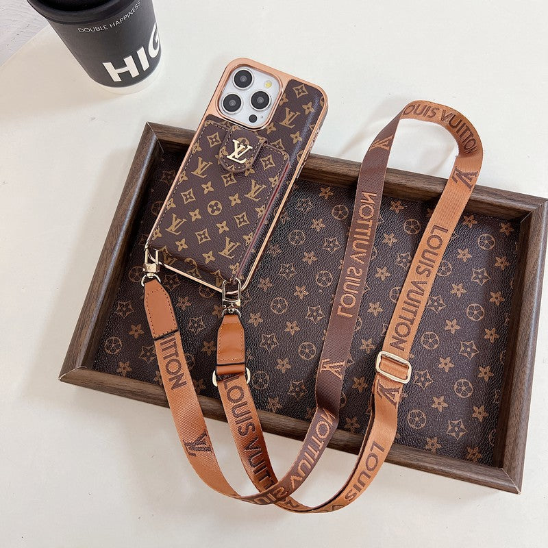 A brown iPhone case with a gold pattern and a matching brown strap with gold lettering.